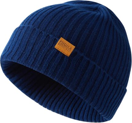Close-up of a knitted FUQILA Merino wool cuff beanie hat in a solid color, showcasing its soft texture.