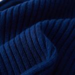Close-up of a knitted FUQILA Merino wool cuff beanie hat in a solid color, showcasing its soft texture.