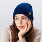 Close-up of a knitted FUQILA Merino wool cuff beanie hat in a solid color, showcasing its soft texture.