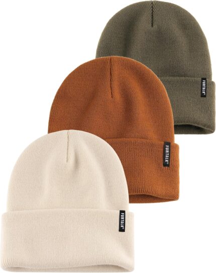 Three cuffed knit beanies in green, caramel, and beige, stacked on a white background, showcasing their soft texture.