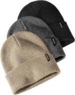 Three cuffed knit beanies in green, caramel, and beige, stacked on a white background, showcasing their soft texture.