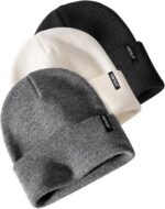 Three cuffed knit beanies in green, caramel, and beige, stacked on a white background, showcasing their soft texture.
