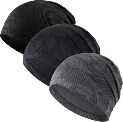 Three WTACTFUL skull caps in black, camo black, and camo gray, folded neatly on a plain background.