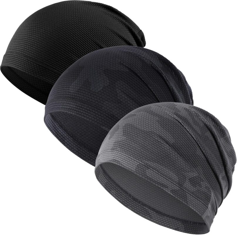 Three WTACTFUL skull caps in black, camo black, and camo gray, folded neatly on a plain background.